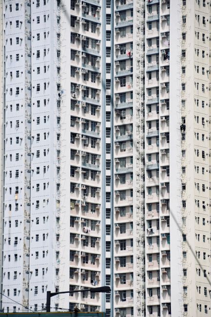 Close-up of a high-rise residential building in Hong Kong, showcasing dense urban architecture.