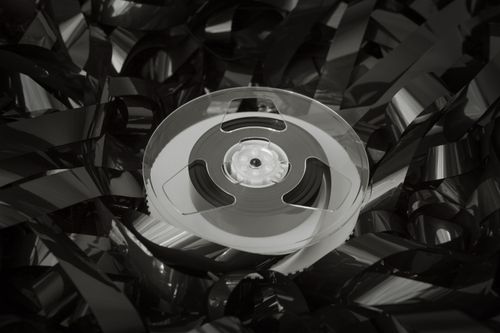 Free Close-up of a vintage cassette reel surrounded by tangled tape, evoking nostalgia and retro vibes. Stock Photo