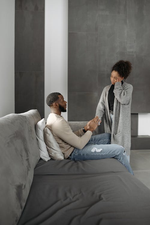 Man In Long Sleeve Shirt Sitting on Gray Couch