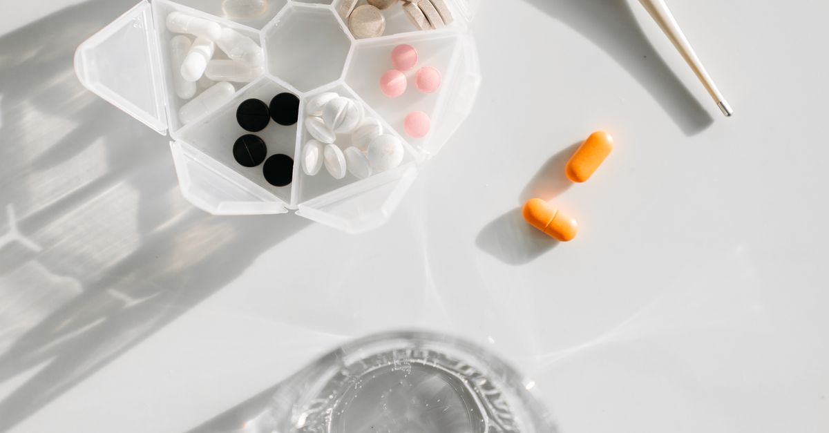 Medicines beside a glass of water