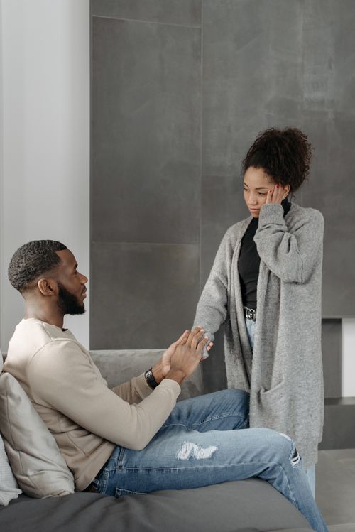 Free A caring partner comforts a sick woman with support and empathy in a modern home setting. Stock Photo