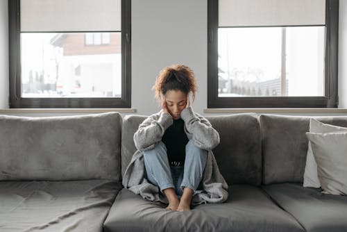 Woman Sitting On A Sofa