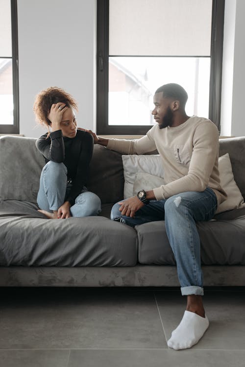 Man And Woman Sitting On A Couch