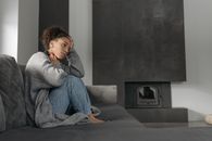 Sick Woman Sitting On A Sofa
