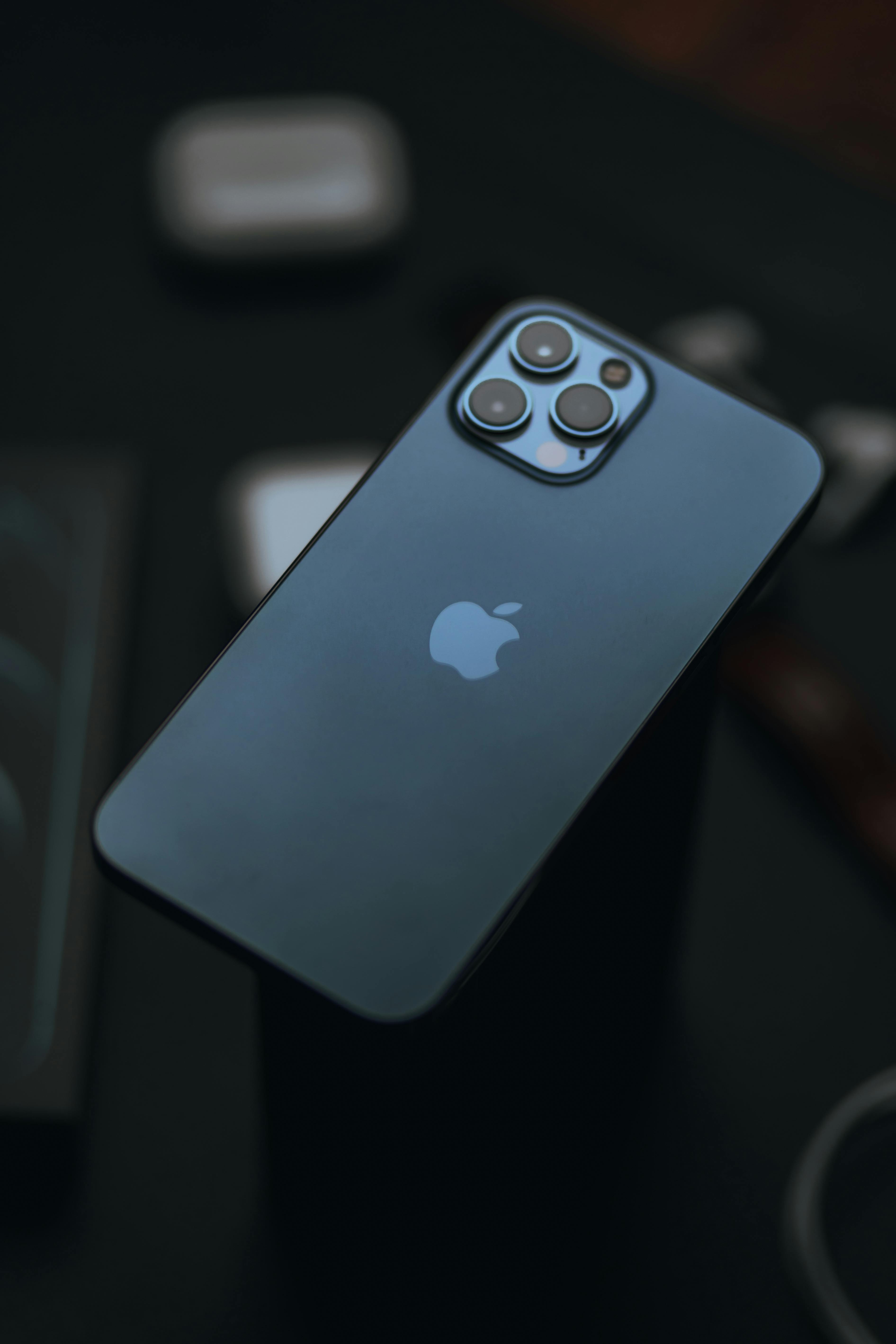 Free From above of modern expensive smartphone with high quality cameras against dark blurred background Stock Photo