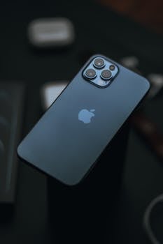 From above of modern expensive smartphone with high quality cameras against dark blurred background