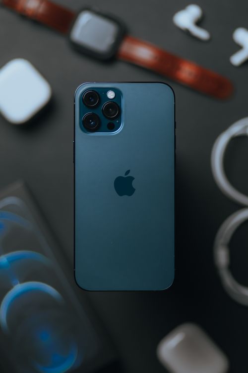 Free From above of contemporary expensive smartphone with high quality cameras against blurred devices placed on table Stock Photo