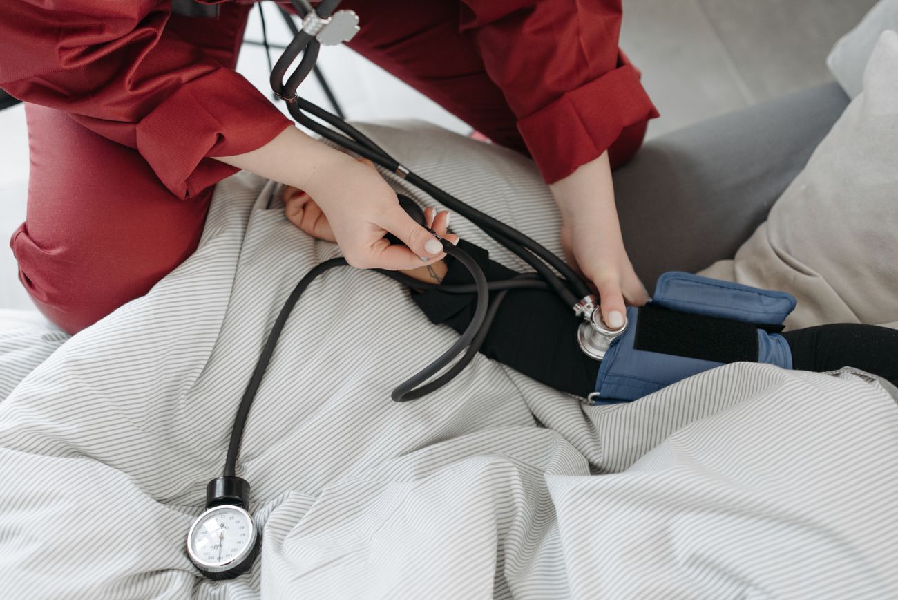 Healthcare professional checking a patient's blood pressure