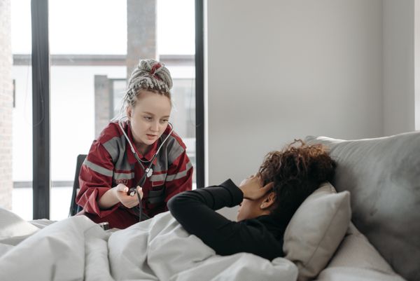 Home care professional assisting patient