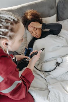 A healthcare professional checking a patient's blood pressure at home.
