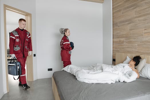 Paramedics assisting an unwell woman lying in bed, showcasing medical intervention indoors.