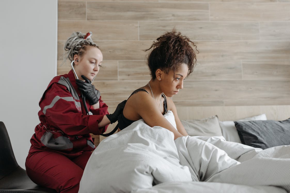 Woman In Red Clothing Checking On Woman