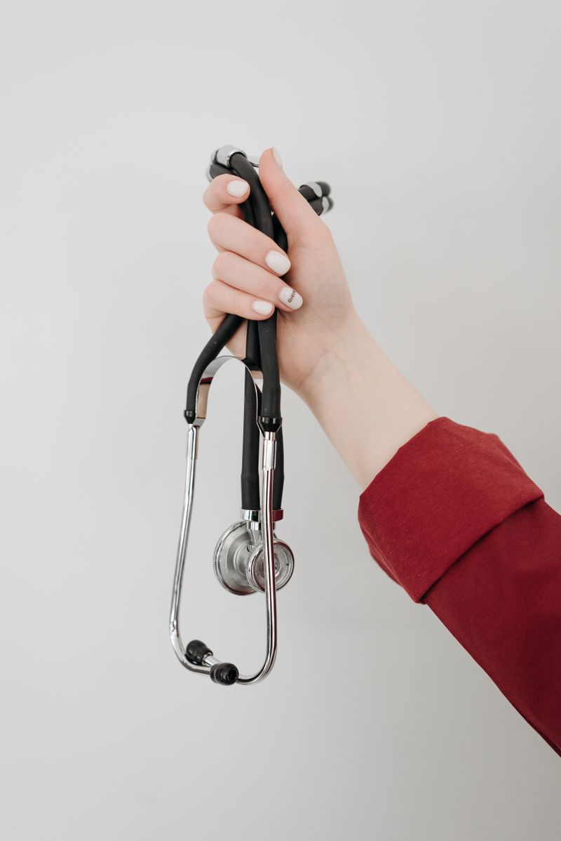 Hand holding a stethoscope