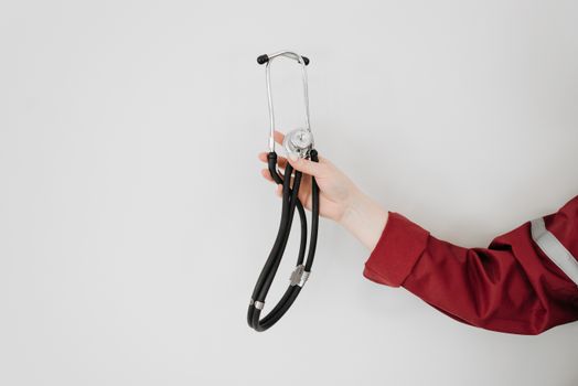 A healthcare worker holding a stethoscope, symbolizing medical care and expertise.