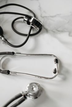 Detailed shot of a stethoscope on a marble background, emphasizing medical themes.