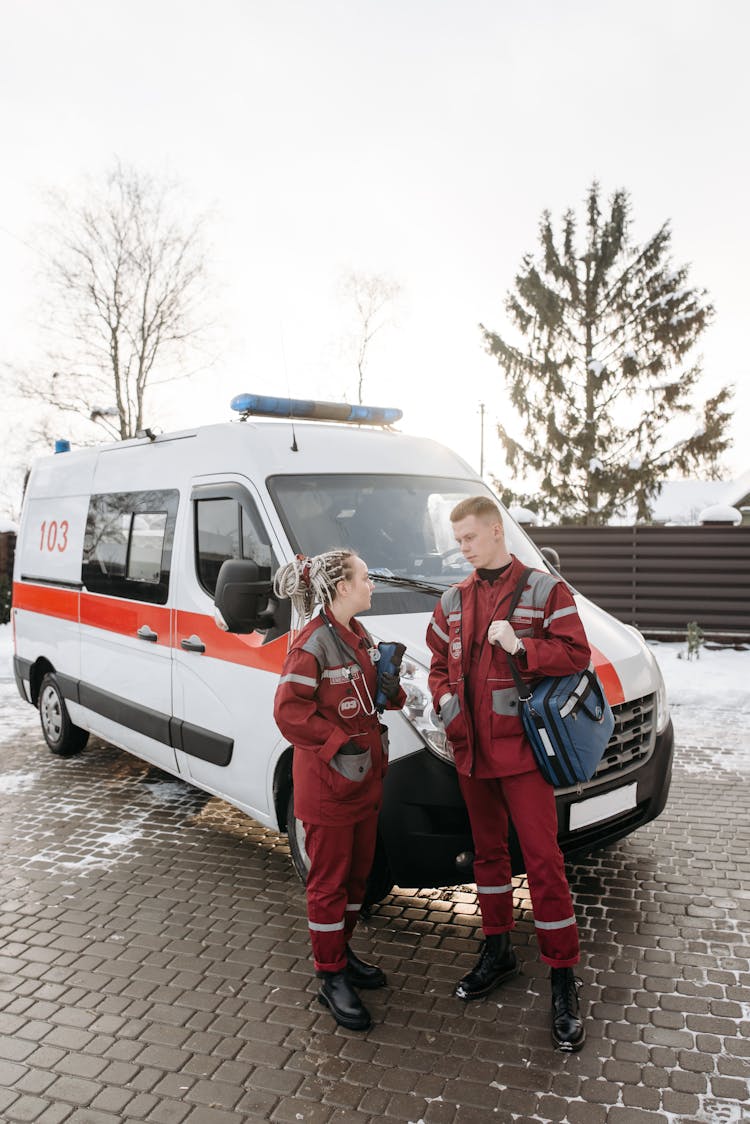 Paramedics Standing Beside An Ambulance