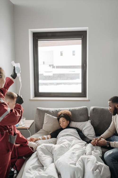 Man Holding Sick Woman's Hand