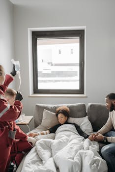 Paramedics providing medical care to a patient in a home setting with family support.