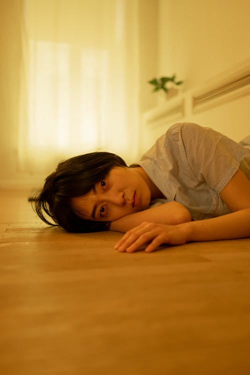 A Tired Looking Woman Lying on the Floor