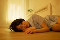 A Woman in Pajamas Lying on the Floor