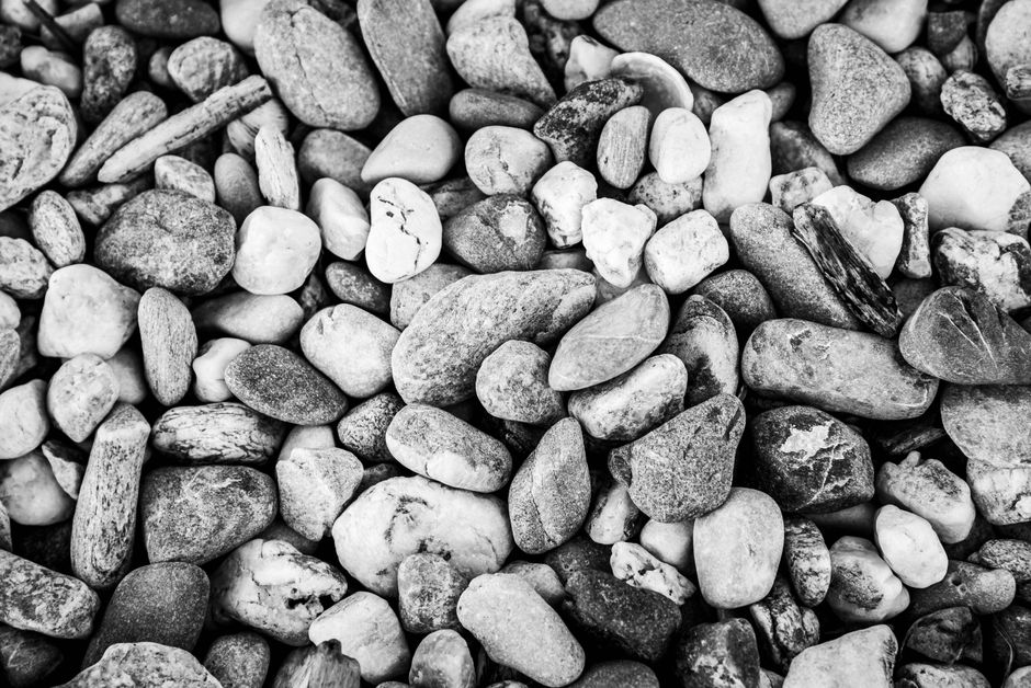 Black and white close-up of pebbles showcasing texture and patterns.