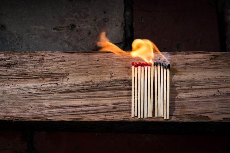 Lighted Matches On Brown Wooden Surface