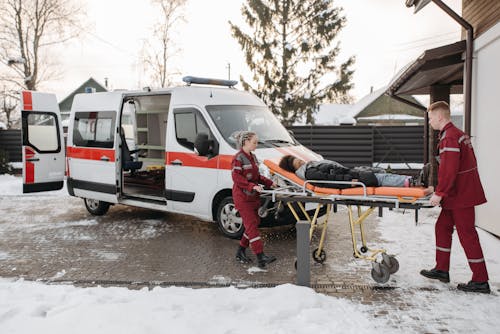 Free EMT Pushing Woman On A Stretcher Stock Photo