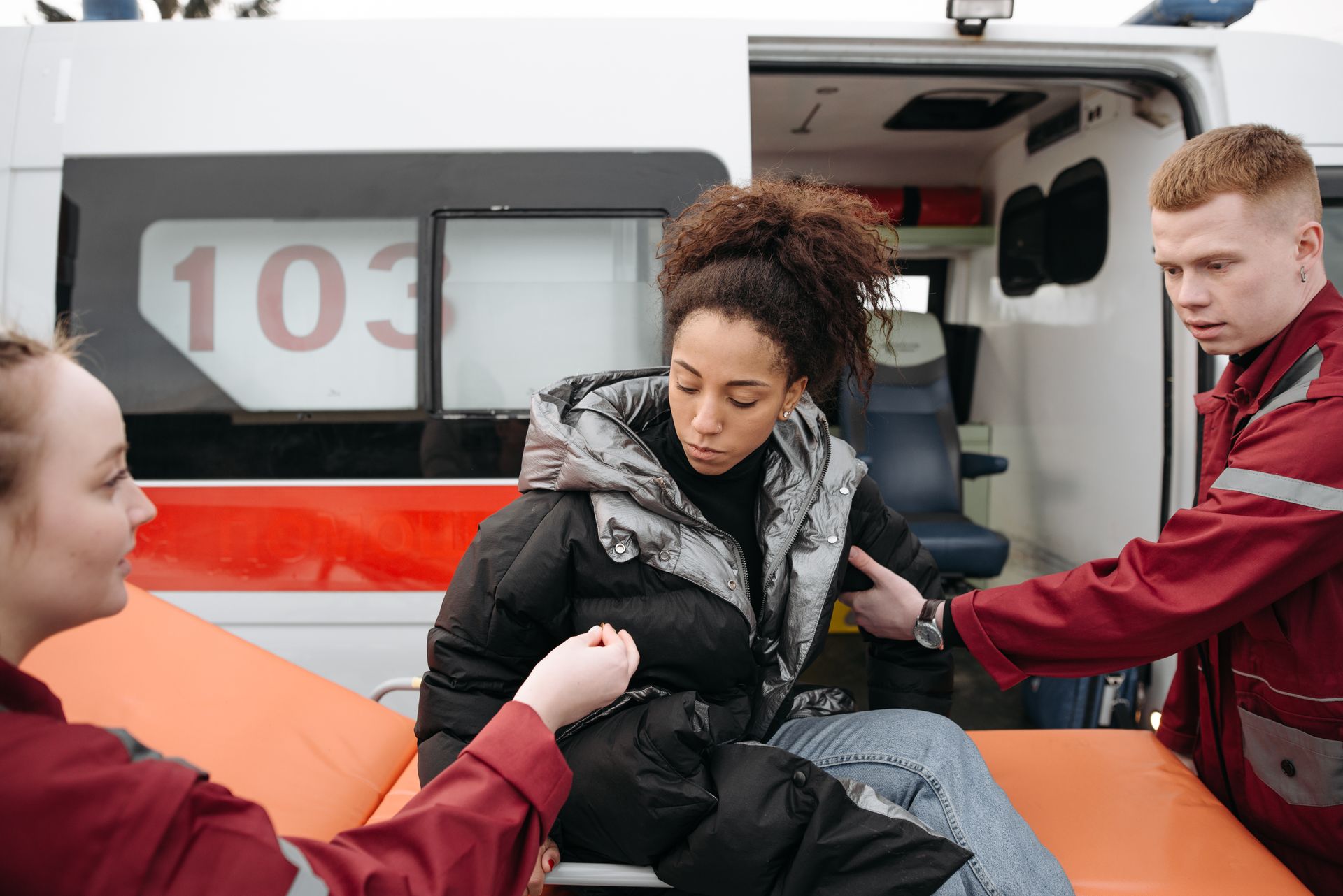 Paramedics Assisting A Woman