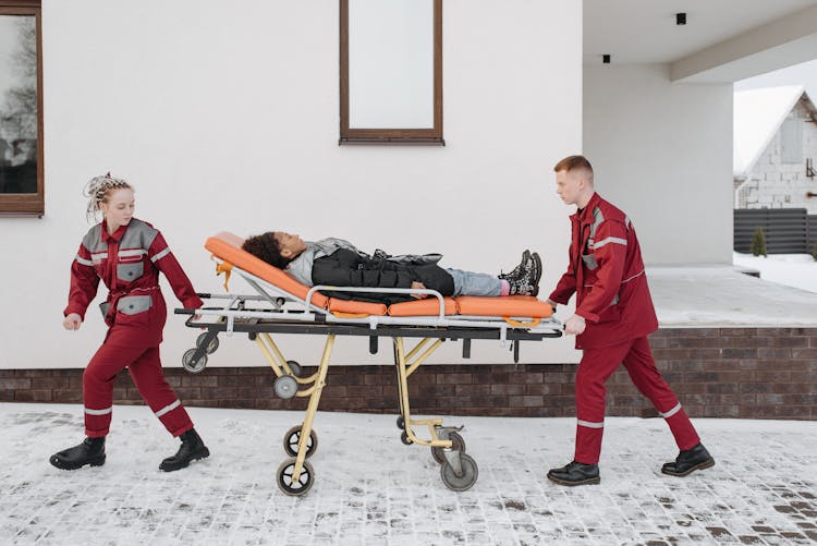 Paramedics Pushing Woman On A Stretcher