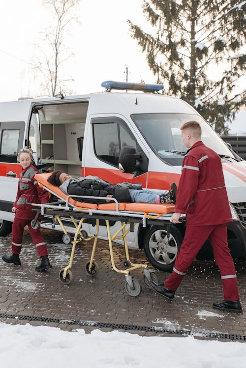 Paramedics Assisting A Woman