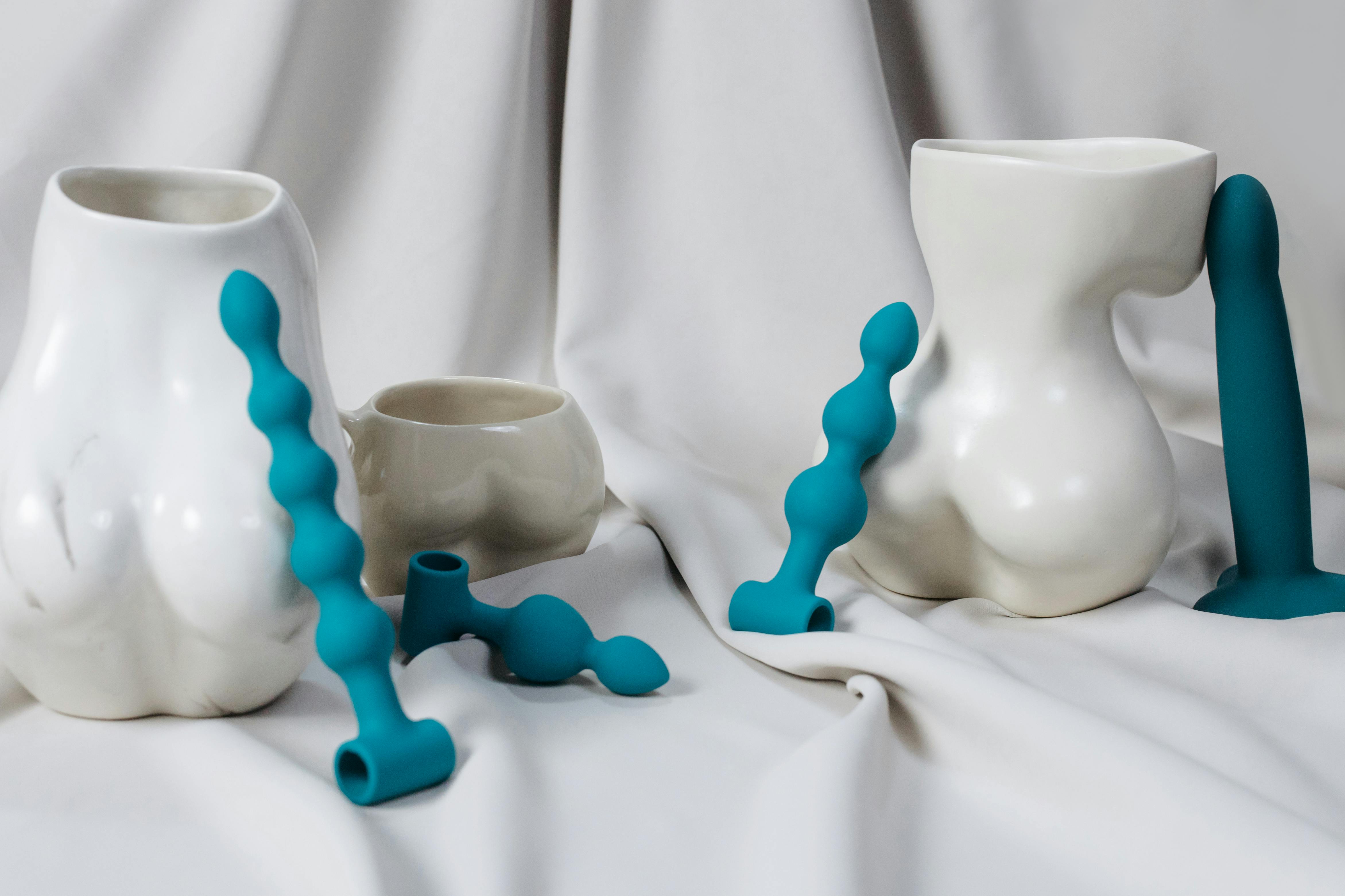 A Ceramic Vases Near the Blue Sex Toys Free Stock Photo