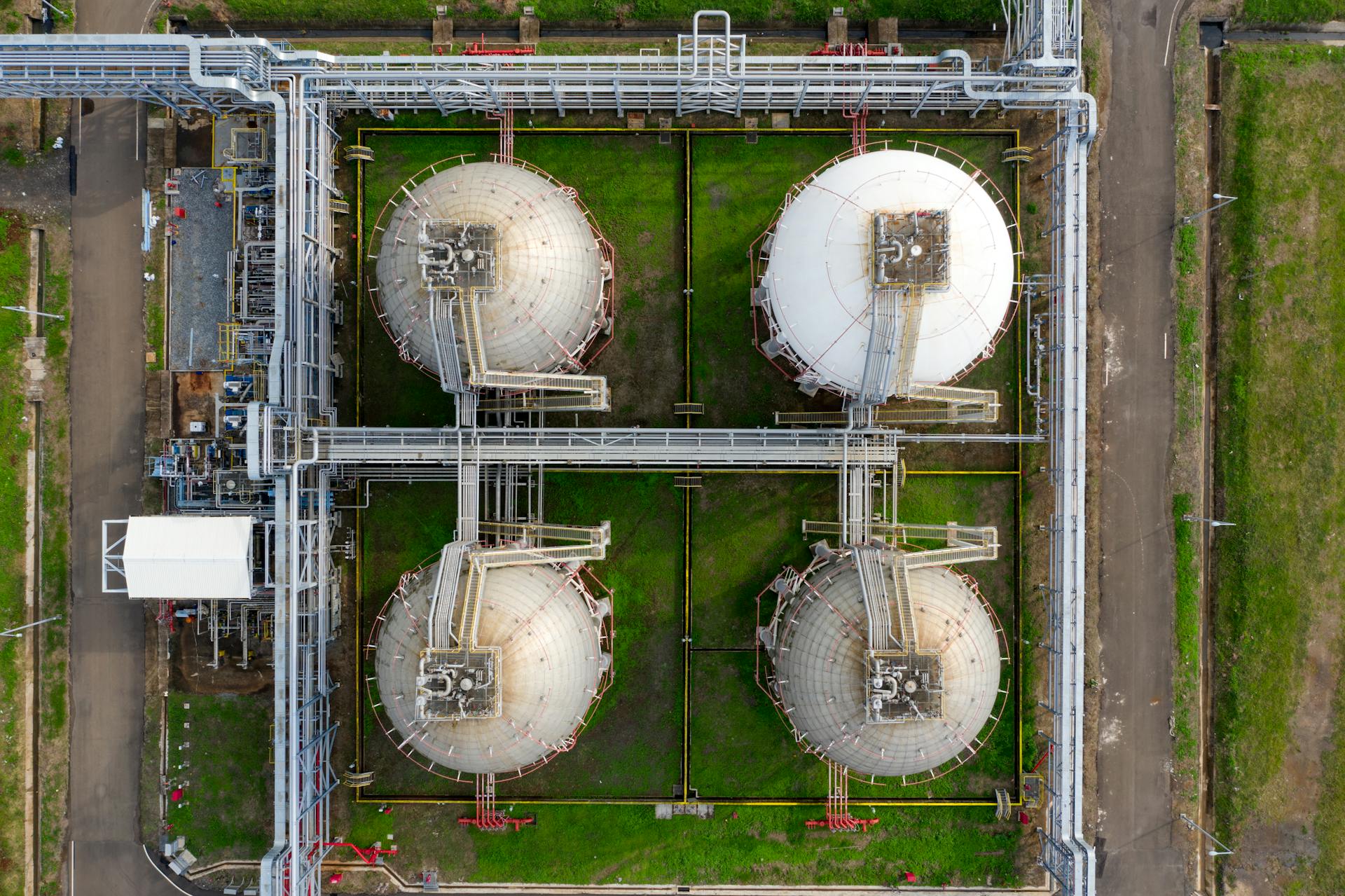 Drone aerial view of industrial silos and pipelines in Banten, Indonesia.