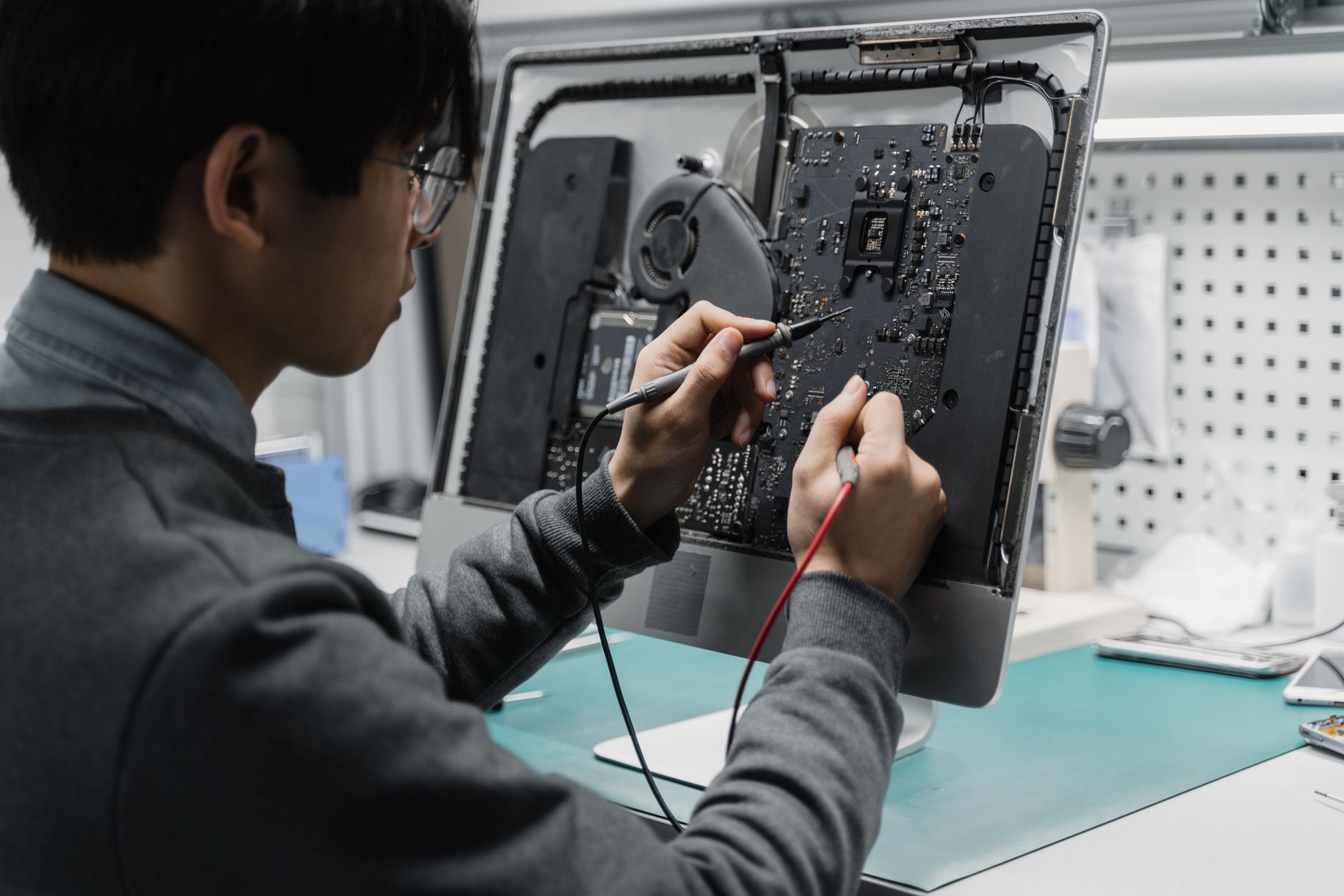IT technician troubleshooting server equipment in a data center