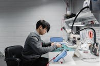 A Man in Gray Sweater Sitting at the Table