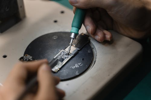 A Person Holding a Soldering Iron