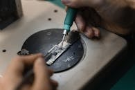 A Person Holding a Soldering Iron