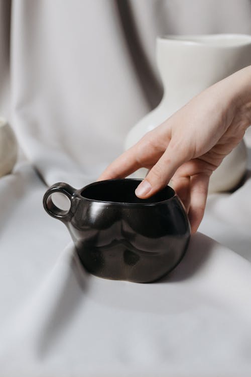 Woman Holding Black Ceramic Cup 