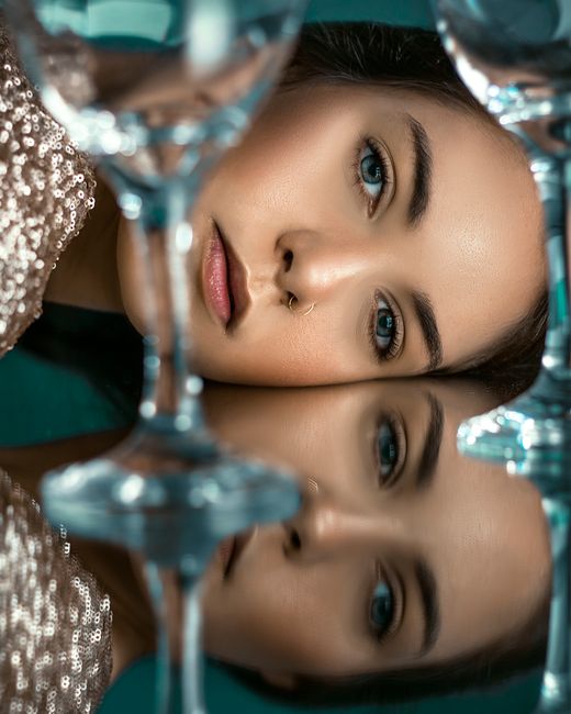 Reflective portrait of a woman with elegant style, showcasing beauty and glamour.