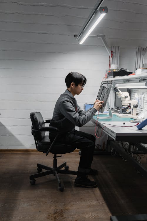 Free A Man Fixing a Motherboard  Stock Photo