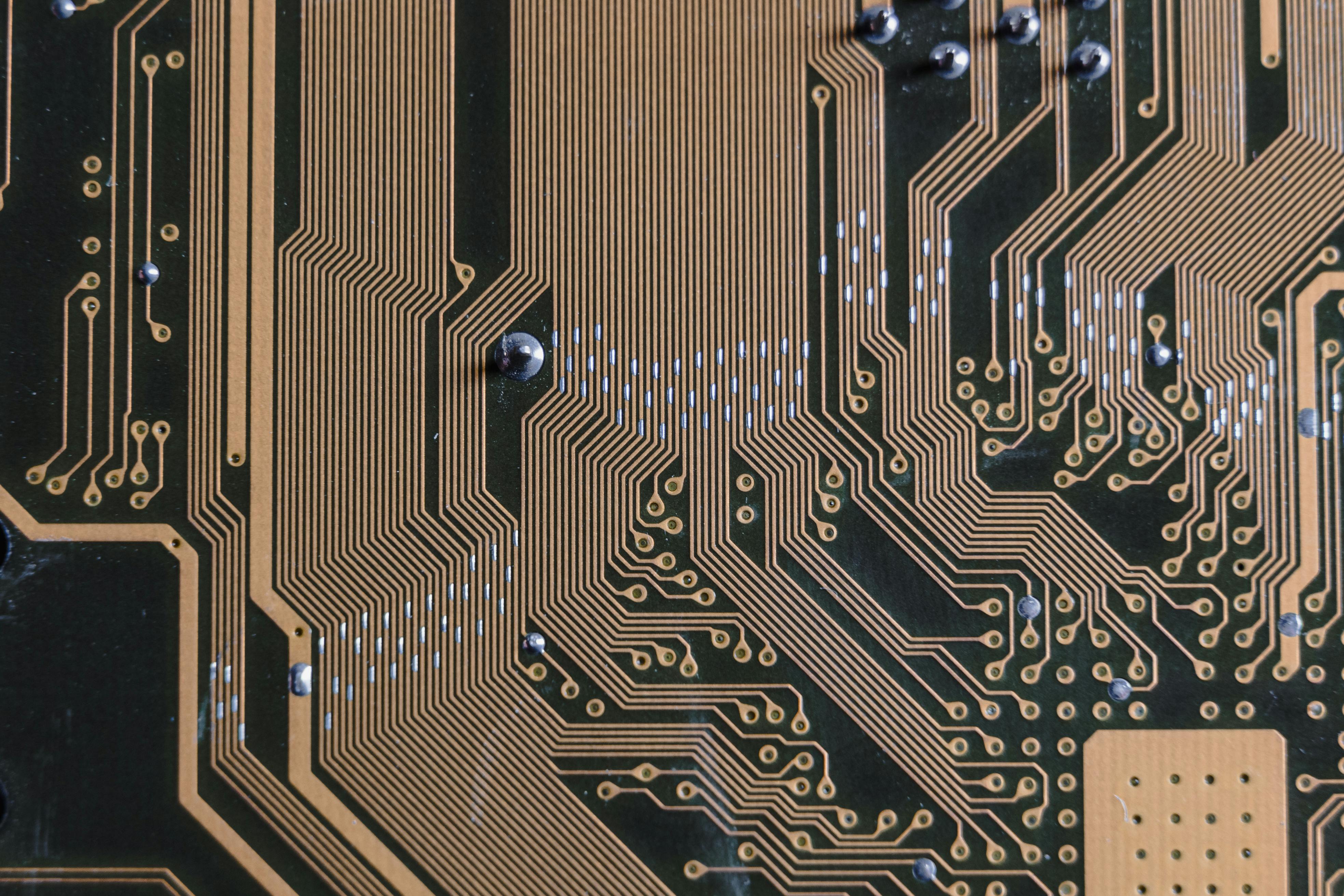 gold circuit board in close up photography