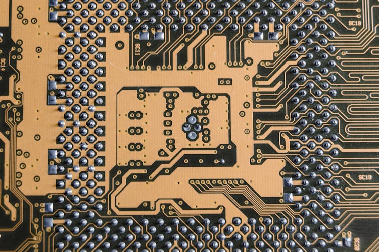 Gold Circuit Board In Close-up Photography