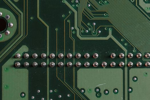 Detailed close-up image of a circuit board showcasing soldered components and circuit pathways.