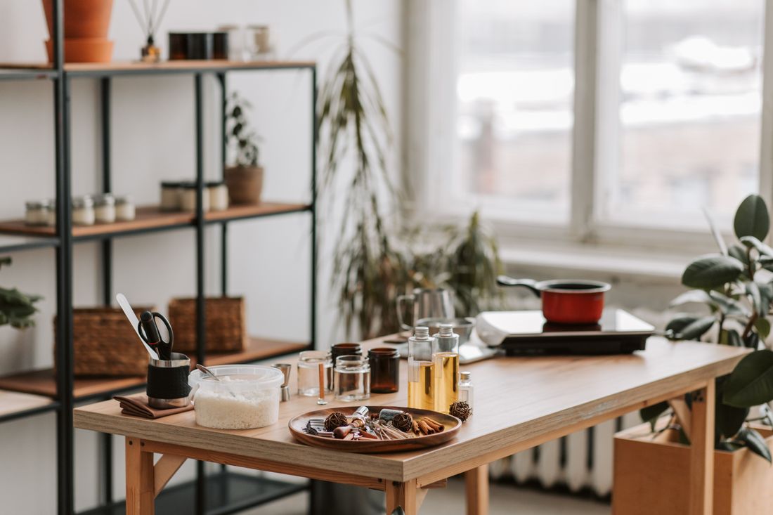 Wax, wicks and glassware laid out on a workbench in a candle studio — Vlada Karpovich on Pexels