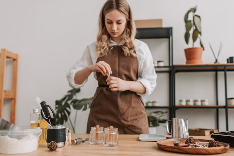 Woman Measuring Ingredients In Kitchen