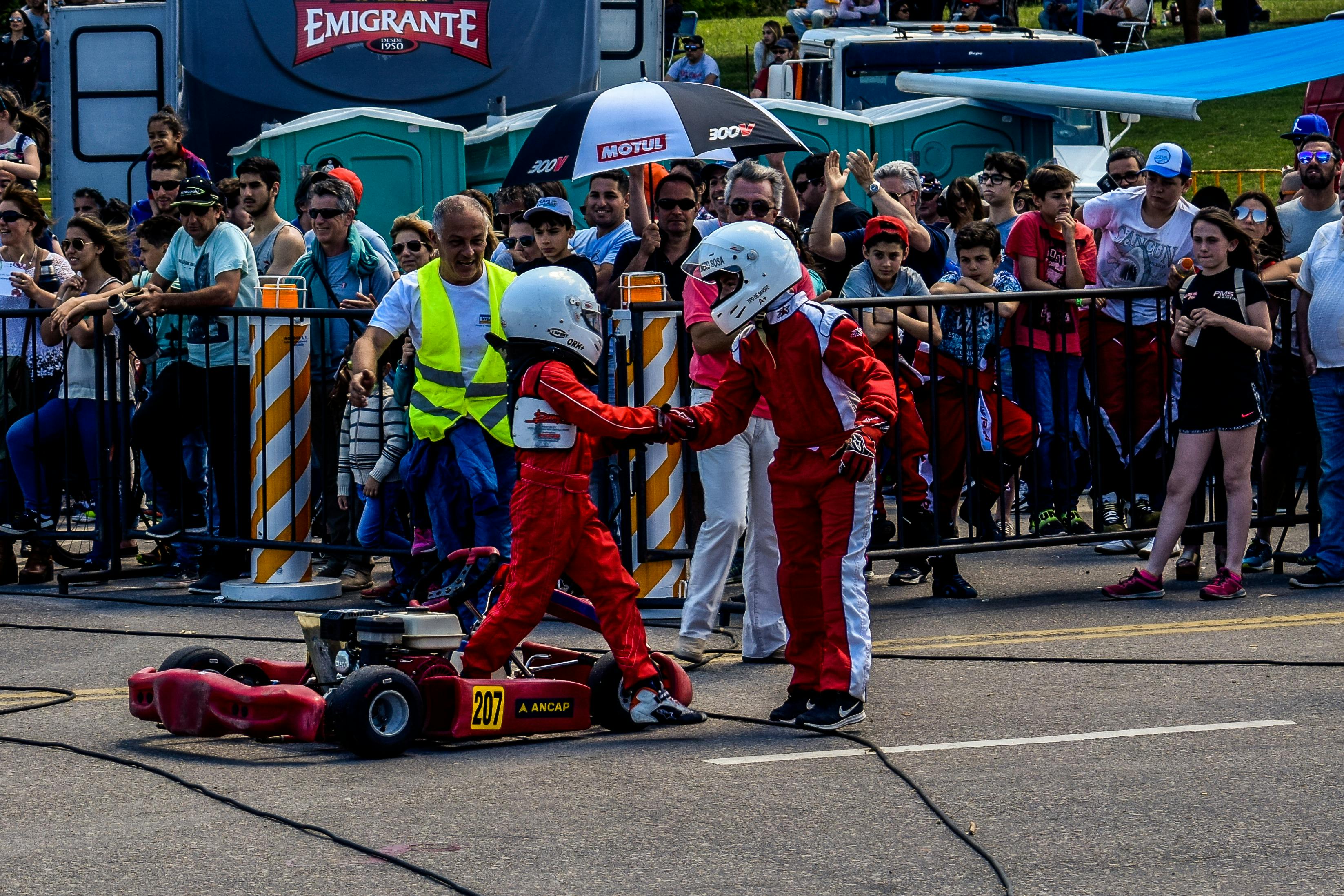 two boy in red and white racing costume