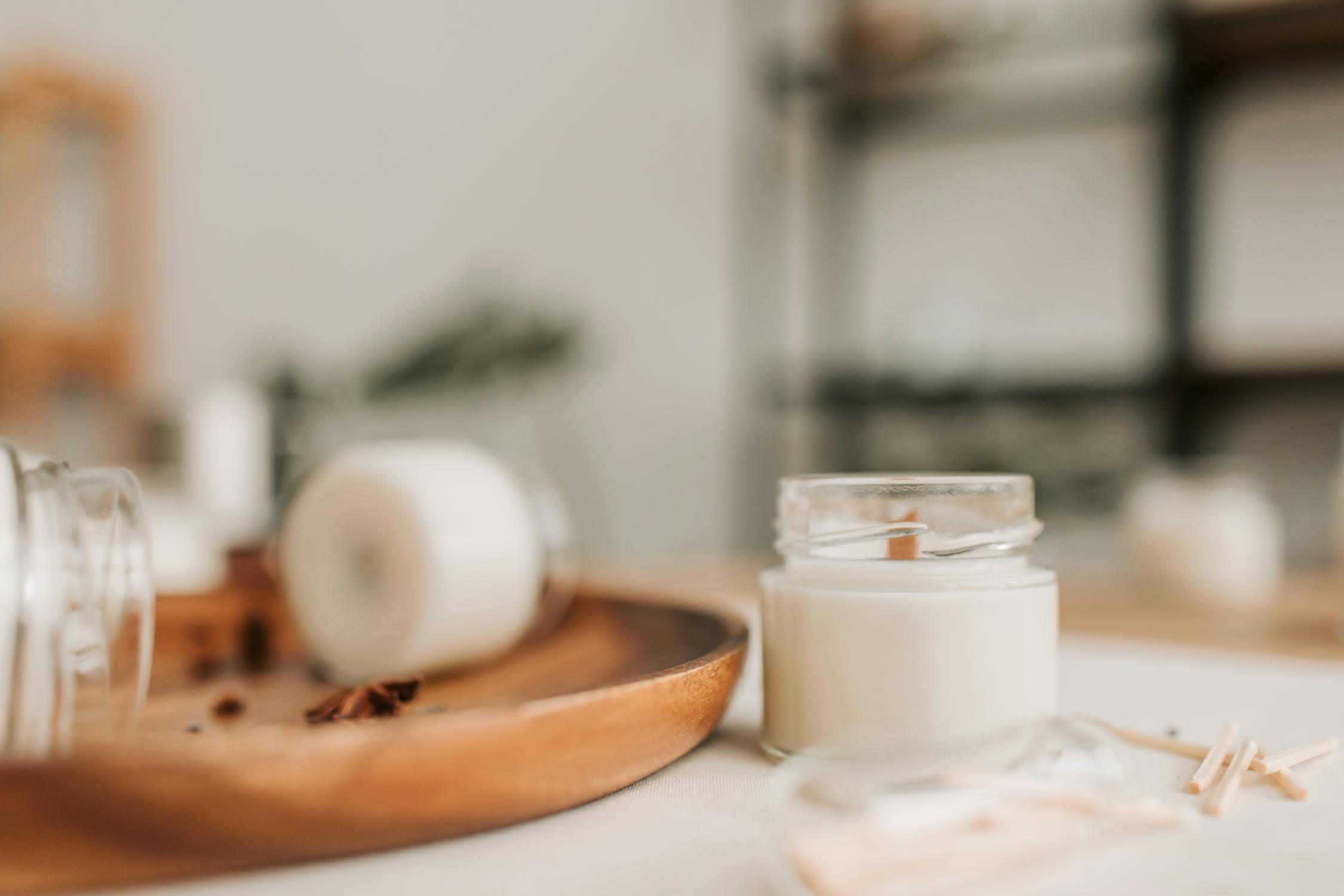 A Close-Up Photograph of a Candle in a Jar