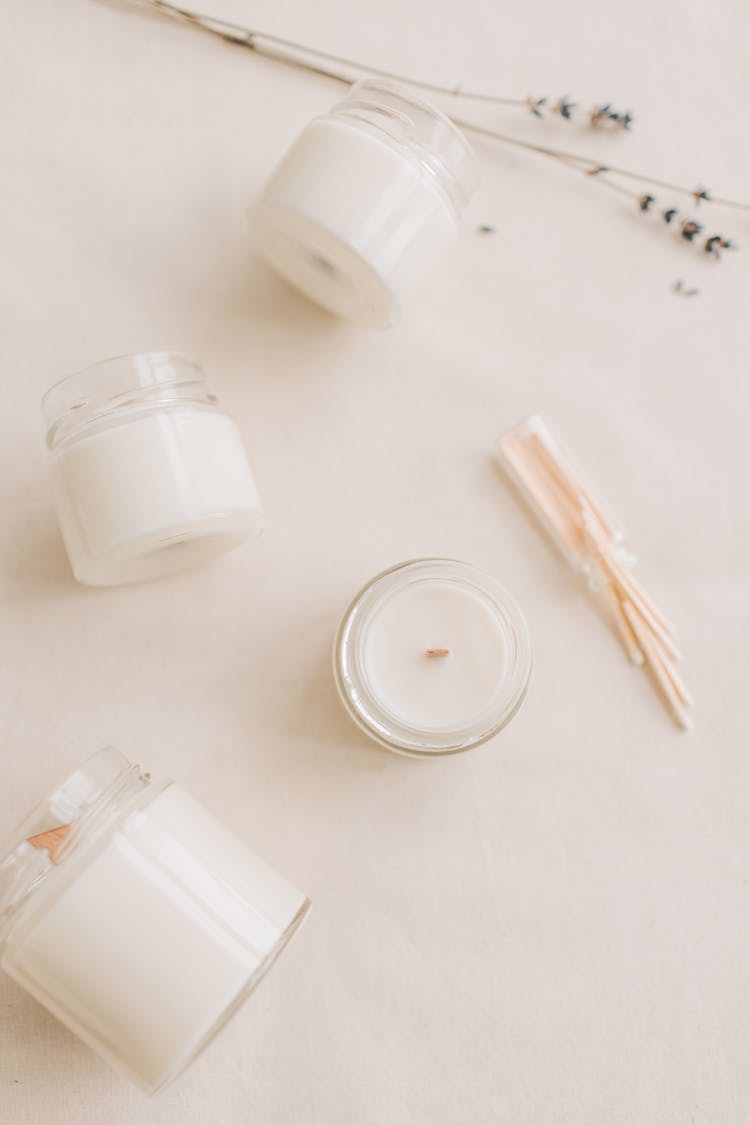 White Candles In Glass Bottles