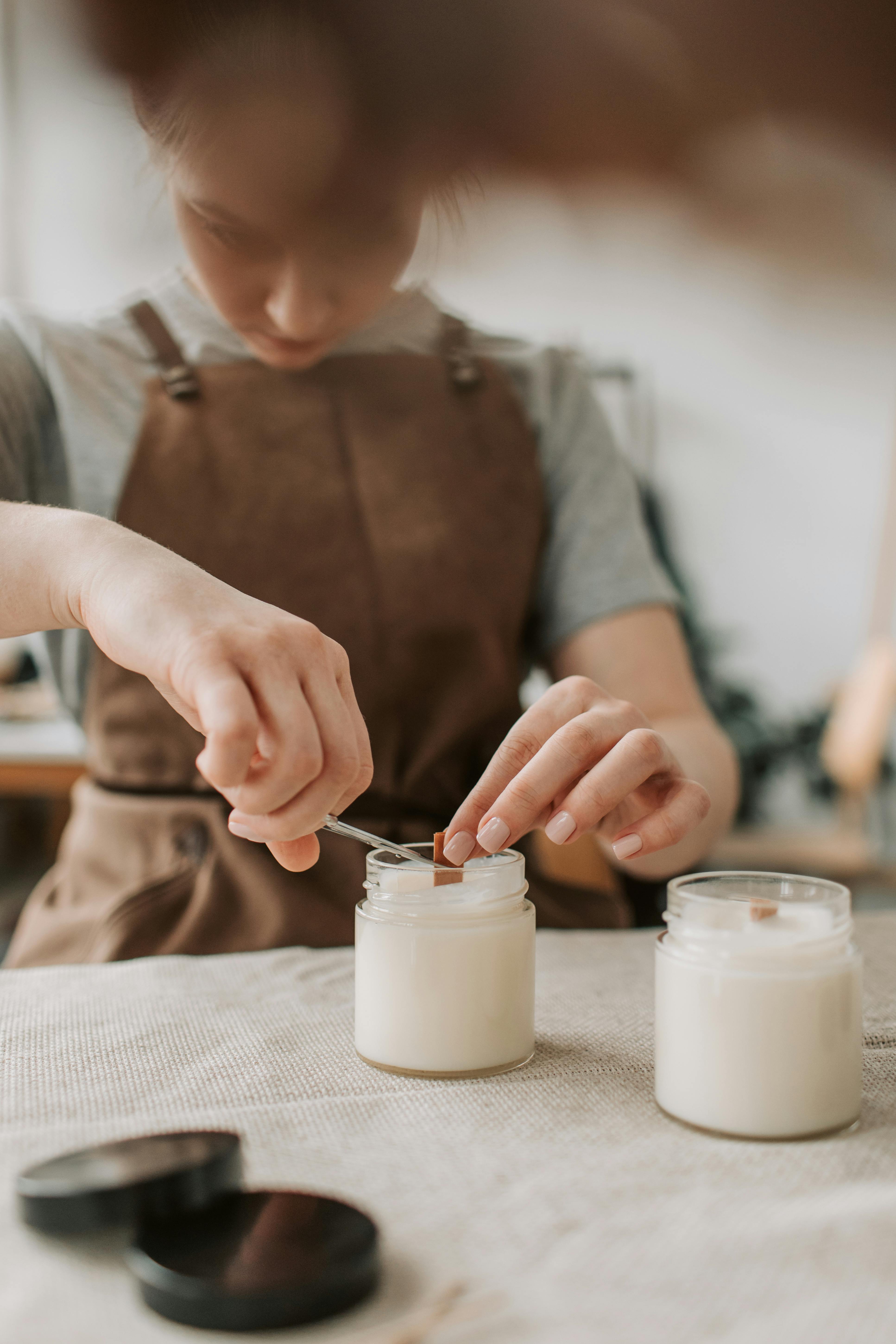 woman fixing a soy candle