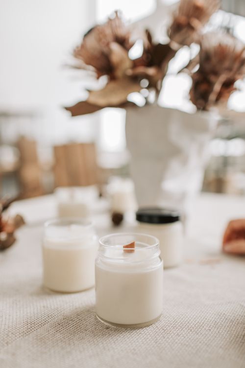 Free Close-up of handmade candles with wooden wicks in glass jars, showcasing artisan quality. Stock Photo