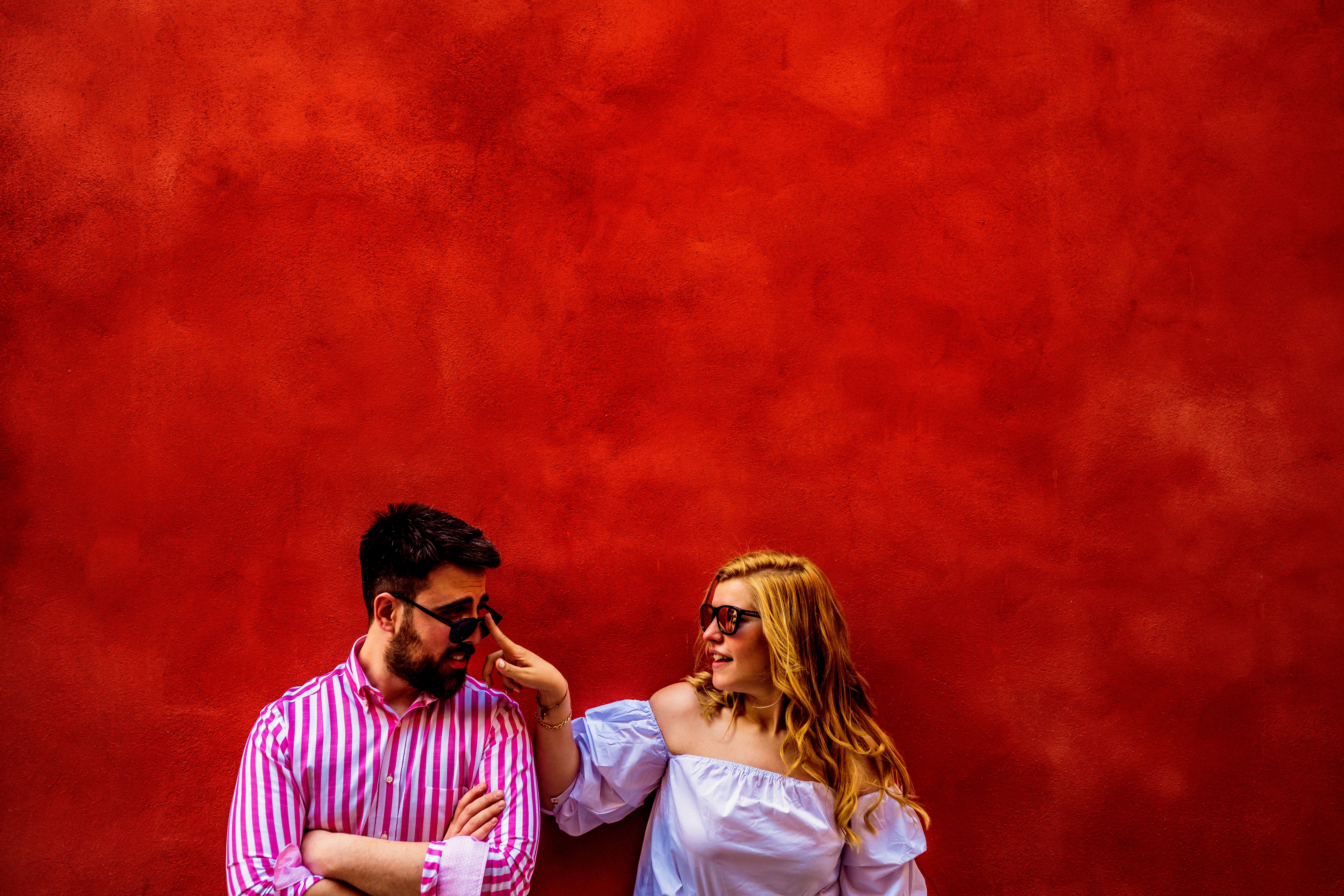 Casal alegre interagindo em um ambiente vibrante.